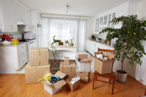 Furniture collection team removing a sofa from a Colneyhatch home