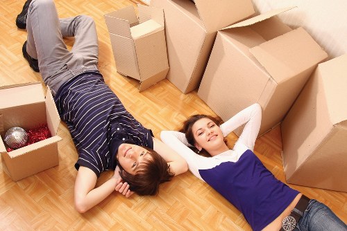 Movers carrying household items into a property in Colneyhatch